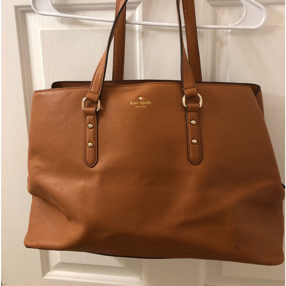 Kate Spade possibly could be “Evangeline”. Carmel colored pebbled leather.